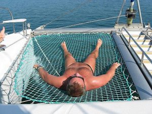 Man on a net of a catamaran