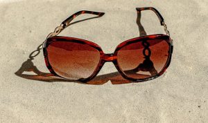 Sun glass on the sand