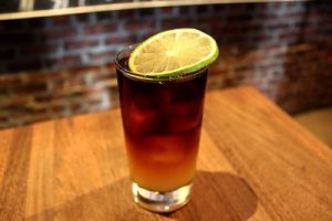 Dark and stormy drink in a glass