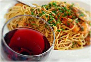 Spaghetti with wine on a table